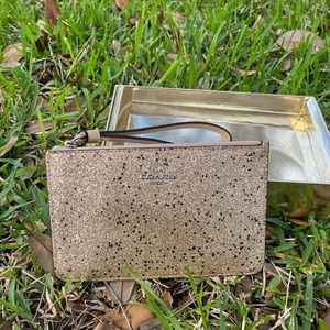 Gold Shinny Coach Wristlet. new